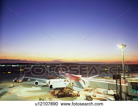 Airplane parked at airport gate View Large Photo Image Stock Image - Airplane parked at airport gate. Fotosearch