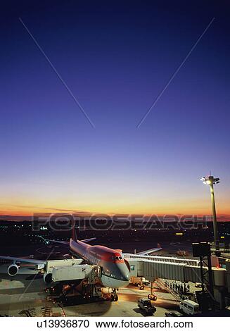 Airplane parked at airport gate View Large Photo Image Stock Image - Airplane parked at airport gate. Fotosearch