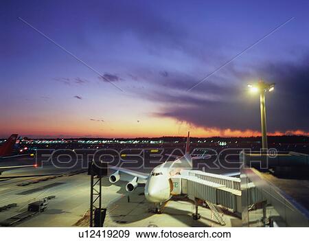Airplane parked at airport gate View Large Photo Image Stock Photo - Airplane parked at airport gate. Fotosearch