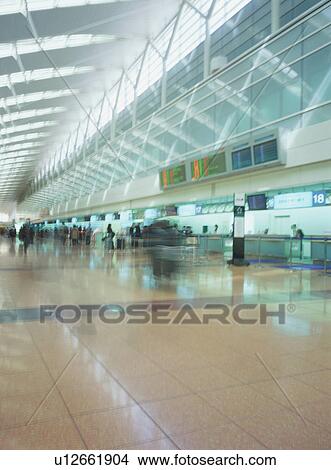 Busy airport terminal, blurred motion View Large Photo Image Picture - Busy airport terminal, blurred motion. Fotosearch