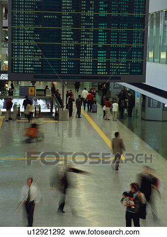 Stock Image - Busy airport terminal, blurred motion. Fotosearch