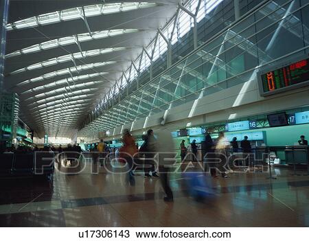 Stock Image - Busy airport terminal, blurred motion. Fotosearch