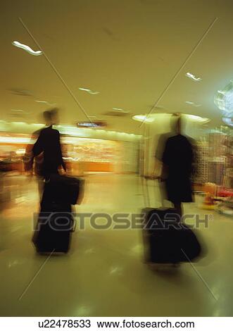 Cabin crews walking with luggage at airport, blurred motion View Large Photo Image Stock Image - Cabin crews walking with luggage at airport, blurred motion. Fotosearch