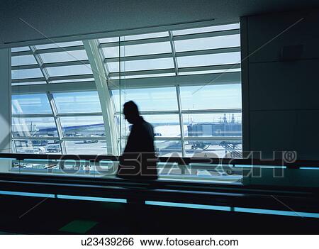 Man standing on moving walkway View Large Photo Image Stock Photograph - Man standing on moving walkway. Fotosearch
