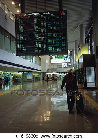 Man walking with luggage at airport, blurred motion View Large Photo Image Stock Photography - Man walking with luggage at airport, blurred motion. Fotosearch