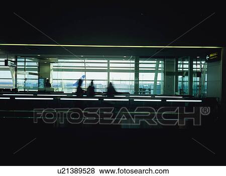 Three people on moving walkway View Large Photo Image Stock Photo - Three people on moving walkway. Fotosearch