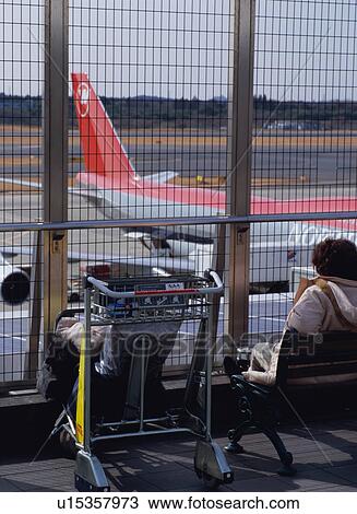 Traveler sitting and looking at airplane View Large Photo Image Stock Image - Traveler sitting and looking at airplane. Fotosearch
