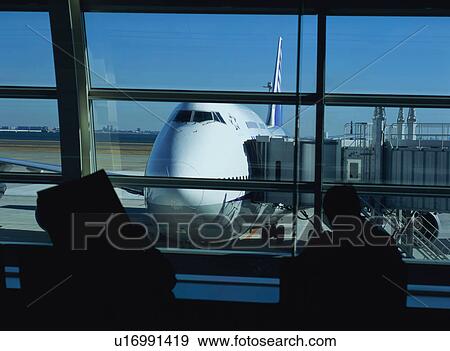 Stock Photo - Traveler waiting to board airplane. Fotosearch