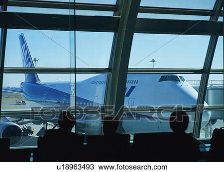 Travelers waiting to board airplane View Large Photo Image Stock Image - Travelers waiting to board airplane. Fotosearch