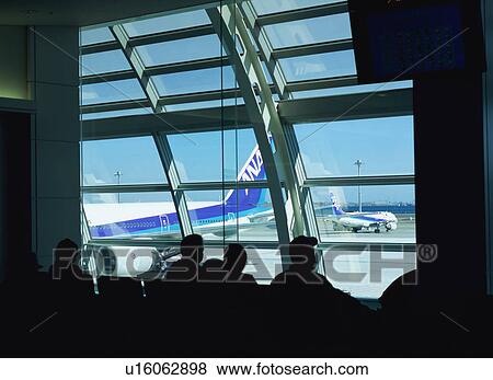 Travelers waiting to board airplane View Large Photo Image Stock Photo - Travelers waiting to board airplane. Fotosearch