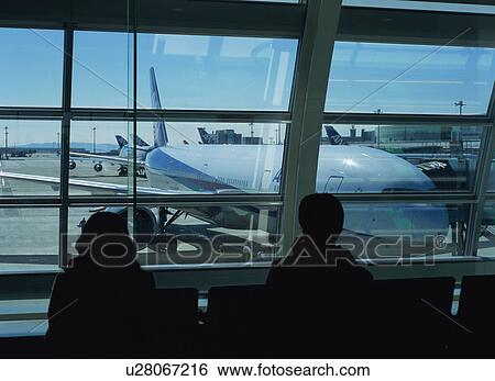 Travelers waiting to board airplane View Large Photo Image Stock Photograph - Travelers waiting to board airplane. Fotosearch