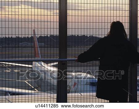 Woman looking at airplane View Large Photo Image Stock Photography - Woman looking at airplane. Fotosearch