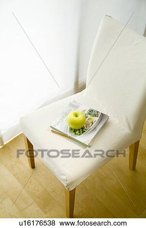 Apple on chair View Large Photo Image Stock Photo - Apple on chair. Fotosearch