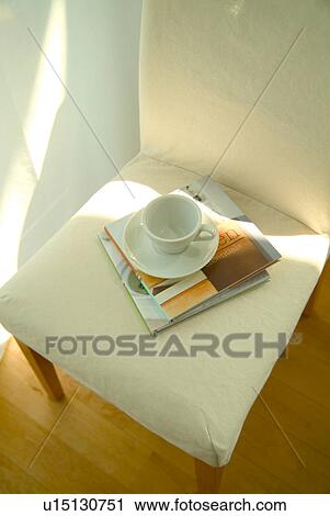Stock Image - Coffee cup on chair. Fotosearch