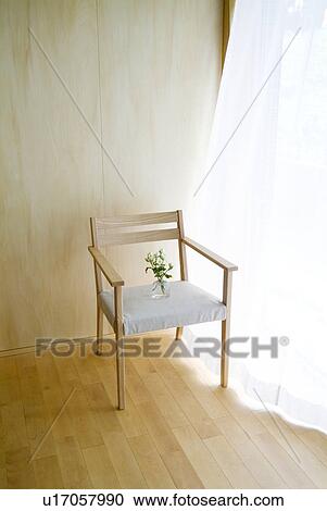 Stock Image - Flower vase on chair. Fotosearch