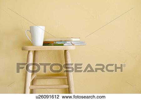 Mug and books on stool View Large Photo Image Stock Image - Mug and books on stool. Fotosearch