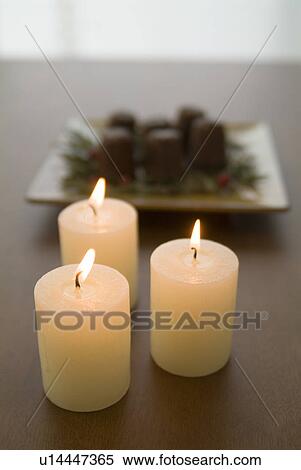 Stock Photography - Candles and canneles. Fotosearch