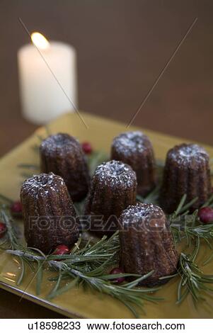 Stock Image - Canneles and candle. Fotosearch