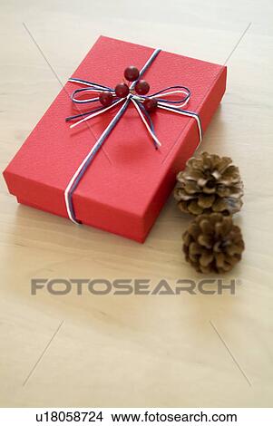 Picture - Christmas present and pine cones. Fotosearch