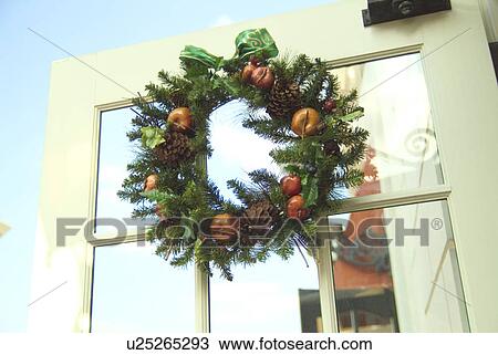 Stock Image - Christmas wreath on door. Fotosearch