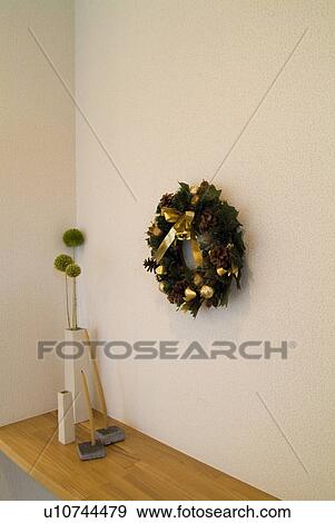 Christmas wreath on wall View Large Photo Image Stock Photo - Christmas wreath on wall. Fotosearch