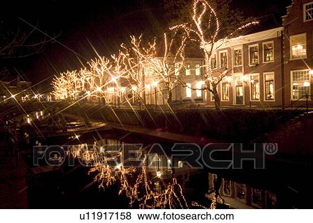 Illuminated trees by river View Large Photo Image Stock Photo - Illuminated trees by river. Fotosearch