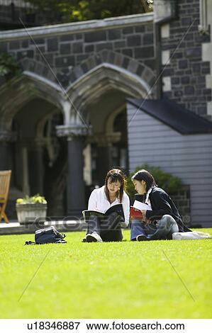 Two young women sitting on lawn View Large Photo Image Stock Photo - Two young women sitting on lawn. Fotosearch