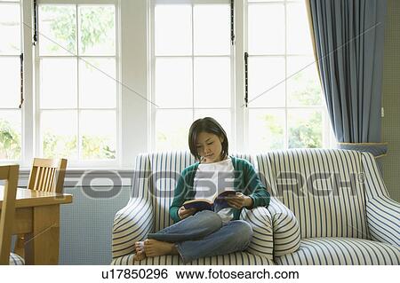 Young woman reading a book View Large Photo Image Stock Photograph - Young woman reading a book. Fotosearch