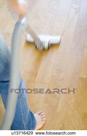A woman cleaning floor with vacuum cleaner, blurred motion View Large Photo Image Stock Photo - A woman cleaning floor with vacuum cleaner, blurred motion. Fotosearch