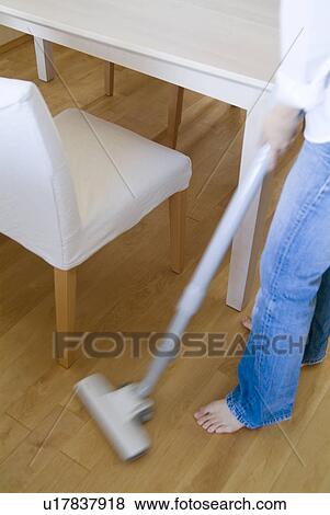 A woman cleaning floor with vacuum cleaner, blurred motion View Large Photo Image Stock Photo - A woman cleaning floor with vacuum cleaner, blurred motion. Fotosearch