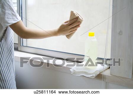 A woman cleaning window View Large Photo Image Picture - A woman cleaning window. Fotosearch