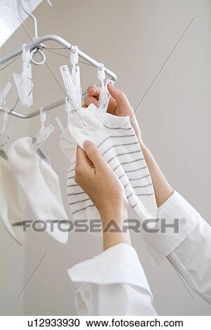 A woman hanging socks to dry View Large Photo Image Stock Image - A woman hanging socks to dry. Fotosearch