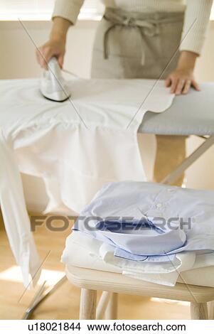 A woman ironing shirt View Large Photo Image Picture - A woman ironing shirt. Fotosearch