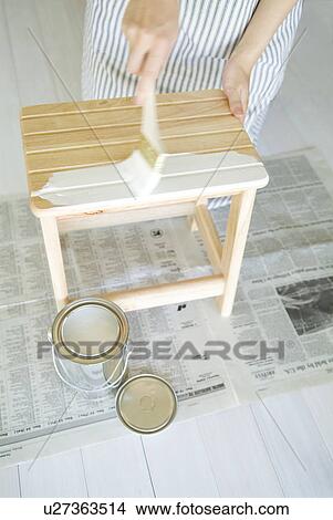 A woman painting a stool View Large Photo Image Picture - A woman painting a stool. Fotosearch