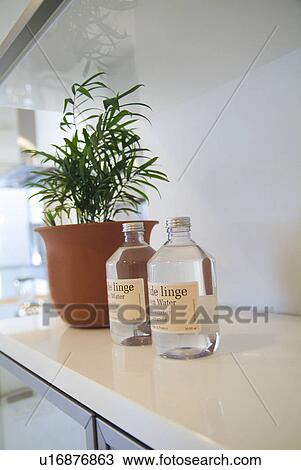 Stock Image - Linen water and potted plant. Fotosearch