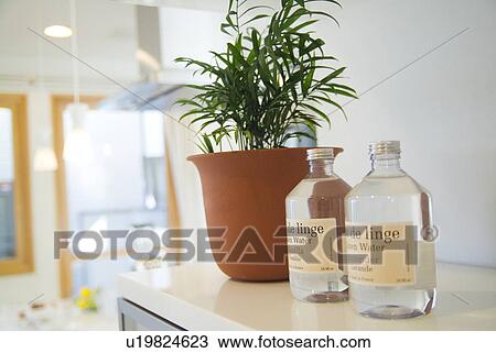 Stock Image - Linen water and potted plant. Fotosearch