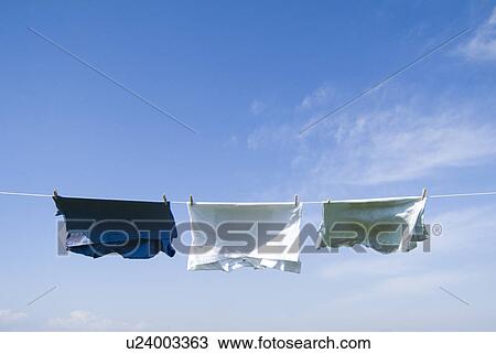T-shirts hanging to dry View Large Photo Image Stock Image - T-shirts hanging to dry. Fotosearch