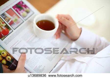 A young woman drinking a cup of tea View Large Photo Image Stock Photograph - A young woman drinking a cup of tea. Fotosearch