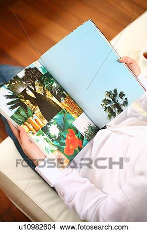 Picture - A young woman reading magazine. Fotosearch