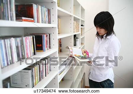 A young woman reading magazine View Large Photo Image Picture - A young woman reading magazine. Fotosearch