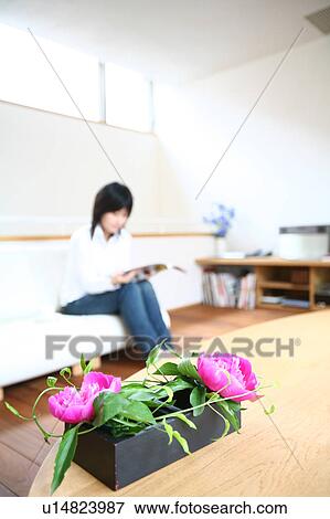 A young woman reading magazine View Large Photo Image Stock Photo - A young woman reading magazine. Fotosearch