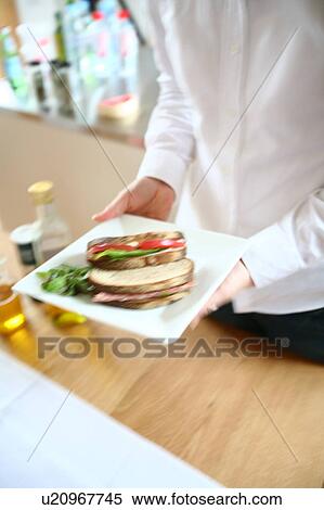 A young woman serving sandwiches on plate View Large Photo Image Stock Photography - A young woman serving sandwiches on plate. Fotosearch