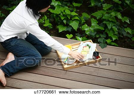 A young woman sitting on wooden porch View Large Photo Image Stock Image - A young woman sitting on wooden porch. Fotosearch