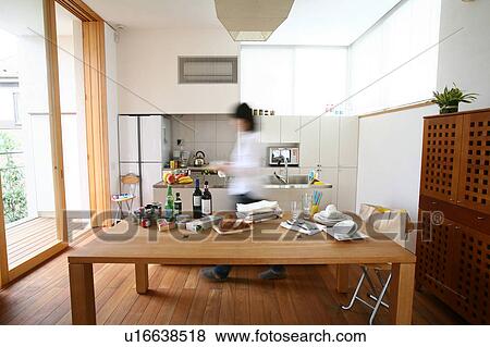 A young woman walking in kitchen, blurred motion View Large Photo Image Stock Photo - A young woman walking in kitchen, blurred motion. Fotosearch