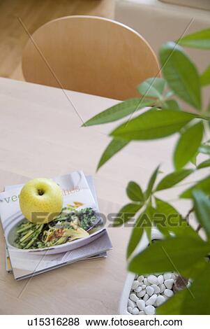 Stock Photo - Apple and books on table. Fotosearch