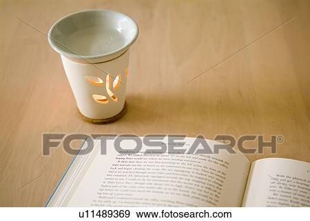 Stock Photo - Aromatherapy burner and book. Fotosearch