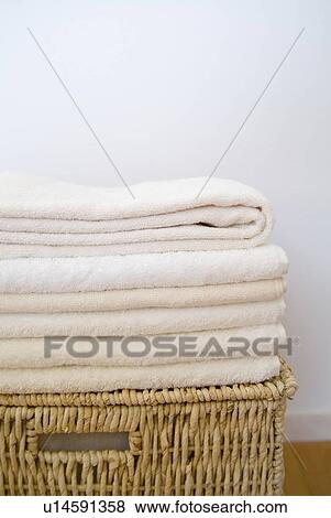 Stock Photo - Folded towels on a basket. Fotosearch