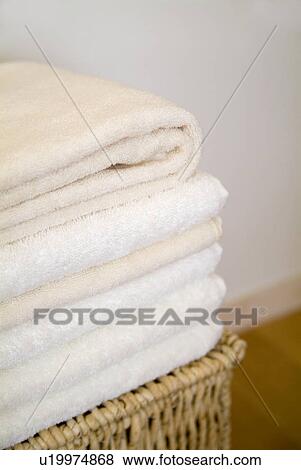 Folded towels on a basket View Large Photo Image Stock Photo - Folded towels on a basket. Fotosearch