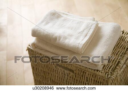 Folded towels on a basket View Large Photo Image Stock Photograph - Folded towels on a basket. Fotosearch