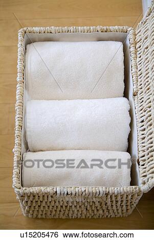 Stock Photograph - Towels in a basket. Fotosearch